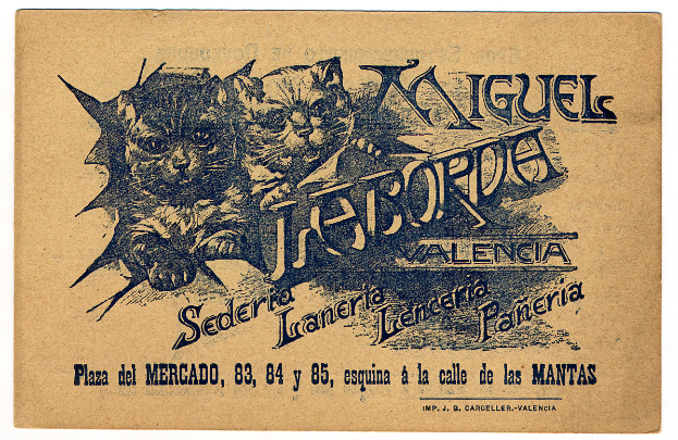 Ein altes Geschäftsblatt mit einem Foto von zwei Katzen, auf dem Text steht, der die Katzen beschreibt.