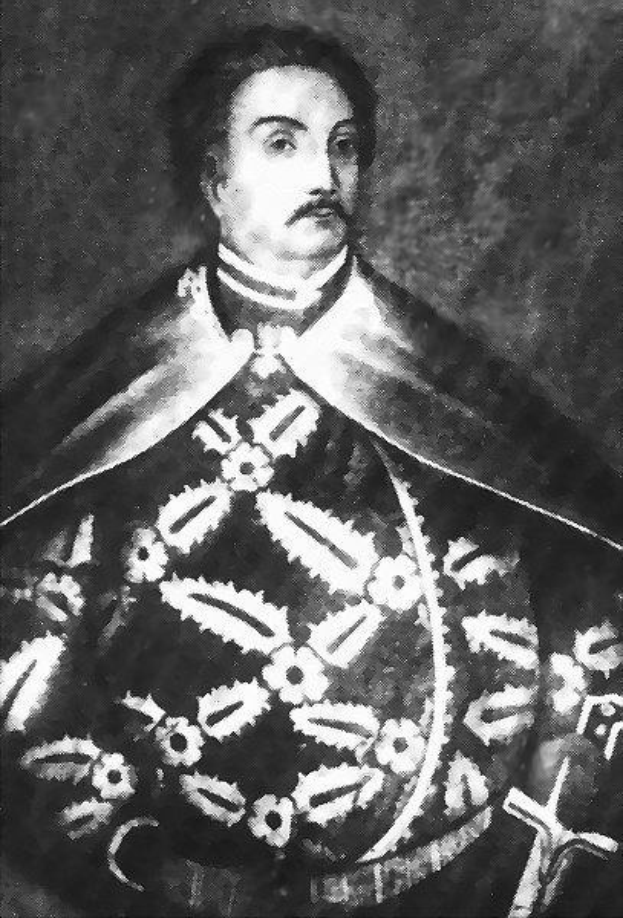 Schwarzes und weißes Foto von Papst Johannes Paul II. in Priesterrobe, trägt eine schwarze Robe mit weißem Kragen und Manschetten, Hände gefaltet, strenger Ausdruck, blickt direkt in die Kamera.