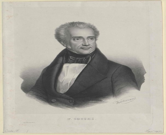 Schwarz-weiß-Porträt des Komponisten F. Cocchi in einem Smoking mit ernster Miene, mit der Aufschrift "Die Musik der Oper" unten.