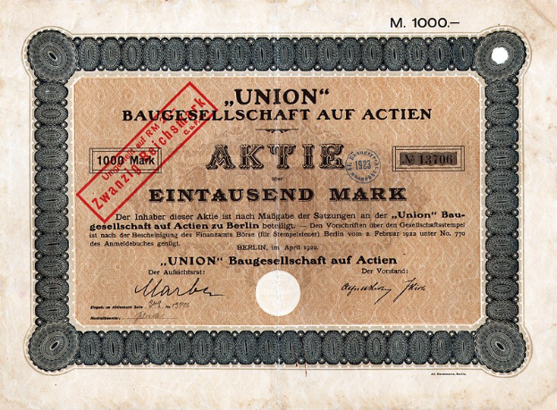 Ein altes deutsches Banknoten mit einem roten Stempel und Text, der darauf hinweist, dass es ein Aktienzertifikat ist.