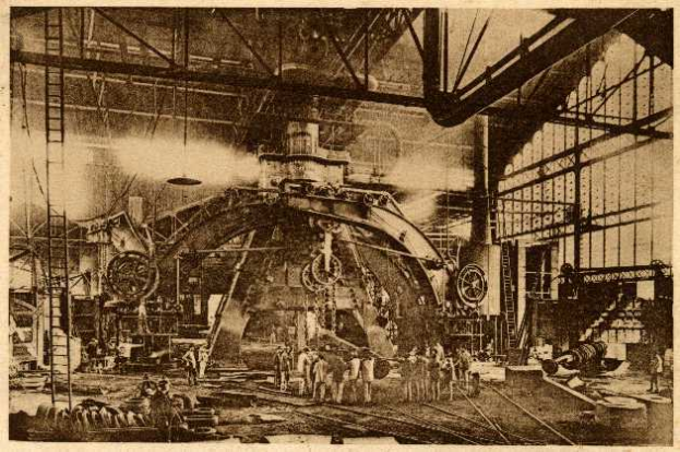 Ein Schwarz-Weiß-Foto eines Fabrikinneren mit Arbeitern an einer großen Maschine, umgeben von Leitern und Stangen, mit dem Text "Cadillac Steel Works" unten.