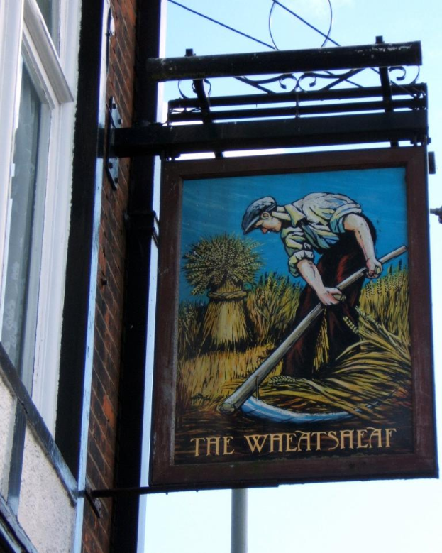 Eine Person steht auf einem Baugerüst an einem Gebäude und hält ein Schwert in der Hand.